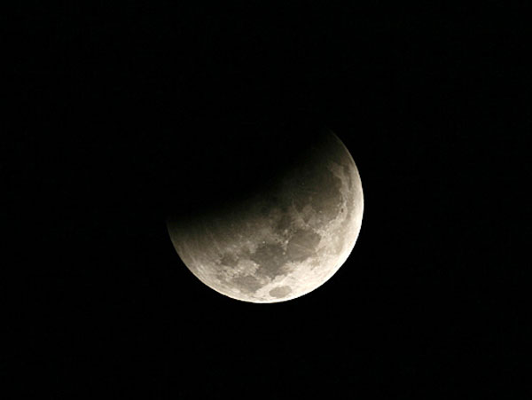 ดวงจันทร์ขณะถูกเงามืดของโลกค่อยๆ บดบังเมื่อเวลาประมาณตี 3 กว่า เหนือท้องฟ้ากรุงเทพมหานครที่สังเกตจากบริเวณที่ทำการสมาคมดาราศาสตร์ไทย (ภาพจาก นายพรชัย อมรศรีจิรทร/สมาคมดาราศาสตร์ไทย)