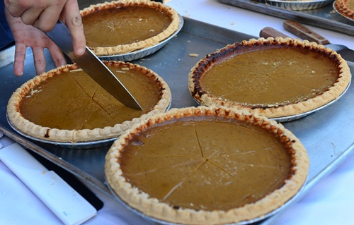 Los Angeles, California, UNITED STATES: A holiday tradition of pumpkin pies are sliced in advance of being served at the annual Los Angeles Mission Thanksgiving meal for the homeless and less fortunate in LAs skid row served by celebrities on November 21, 2012 in California. The LA Mission started as a soup kitchen for men of the depression era in 1936 and continues serving meals each day, providing emergency shelter, and helping men and women restore their lives to get back on their feet. AFP PHOTO/Frederic J. Brown