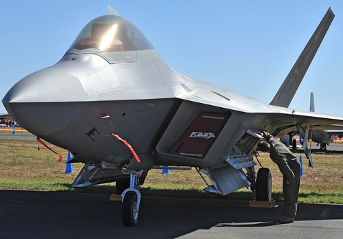 Melbourne, Victoria, AUSTRALIA: US Air Force Lt Col Jeff Hawkins of the 94th Fighter Squadron inspects a F-22 Raptor during the Australian International Airshow in Melbourne on March 1, 2013. 180,000 patrons are expected through the gates over the duration of the event staged at the Avalon Airfield some 80kms south-west of Melbourne. AFP PHOTO/Paul Crock