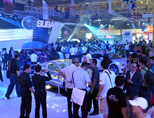 Manila, PHILIPPINES: Visitors crowd around cars on display at the auto show in Manila on April 4, 2013. The annual auto show is being held from April 4 to 7 at the world trade center. AFP PHOTO/Ted Aljibe