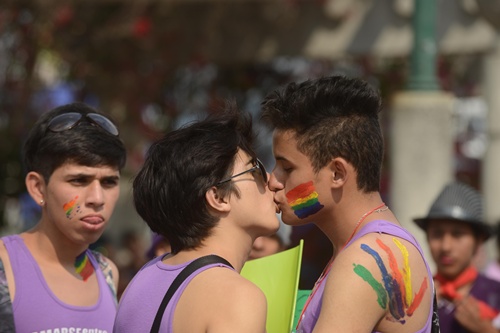 Guatemala City, GUATEMALA: Guatemalan members of the transsexual, gay and lesbian community kiss during a march during the International Day Against Homophobia in Guatemala Ccity on May 17, 2013. AFP PHOTO/Johan Ordonez