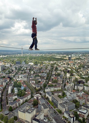 Frankfurt am Main, Hessen, GERMANY: Austrian slackliner Reinhard Kleindl balances on a cord between the two towers of the Tower 185as part of the skyscraper festival in Frankfurt am Main, western Germany, on May 25, 2013. The festival takes place from may 25-26, 2013 and is expected to attract hundred thousands of visitors. AFP PHOTO/Nicolas Armer