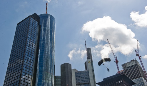 Frankfurt am Main, Hessen, GERMANY: A base-jumper floats down with a parachute after jumping off the Maintower as part of the skyscraper festival in Frankfurt am Main, western Germany, on May 25, 2013. The festival takes place from may 25-26, 2013 and is expected to attract hundred thousands of visitors. AFP PHOTO/Nicolas Armer 