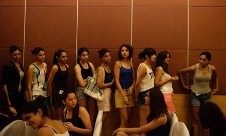 Mumbai, INDIA: Models wait for their turn to appear before the judges during the Indian Lakme Fashion Week (LFW) model auditions in Mumbai on July 3, 2013. Some 86 Indian and international models participated in the audition from which seven models were selected. The LFW inter/Festive 2013 collection show is scheduled to be held in Mumbai in the month of August. AFP PHOTO/Punit Paranjpe