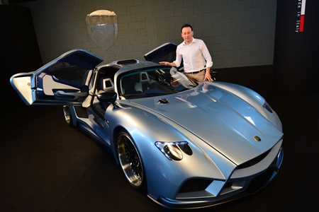 PONTERDERA, ITALY: The head of Mazzanti Automobili, Luca Mazzanti, poses with an Evantra supercar on July 9, 2013 in the workshop of Mazzanti Automobili in Pontedera near Pisa. Mazzanti automobili build exclusive tailor-made supercars, produced only in very limited series, each of them individually personalized. AFP PHOTO/Giuseppe Cacace