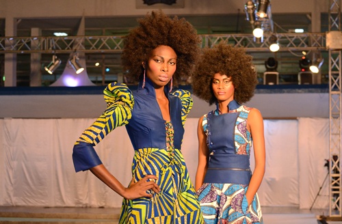 Kinshasa, DEMOCRATIC REPUBLIC OF CONGO: Models parade on the catwalk on July 26, 2013 in Kinshasa, on the first day of the three-day first Fashion Week in Kinshasa. While the army is battling rebels in the Democratic Republic of Congos unstable east, models prepared to sashay down the catwalk at the first Fashion Week in the capital Kinshasa, which has one of the highest murder rates in the world. Gloria Mteyu, 29, told AFP that she had organised the three-day catwalk and fashion exhibition to show that  in Congo, there is not just war. AFP PHOTO/Aziz Tutondele
