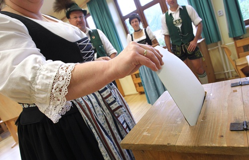 Bad Hindelang, Bavaria, GERMANY: A woman wearing a traditional bavarian dress from the Allgaeuer region casts her ballot at a shool turned into a polling station on on September 22, 2013 in Bad Hindelang, southern Germany, the day of the German general elections. AFP PHOTO/DPA/Karl-Josef Hildenbrand