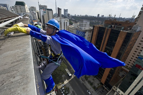 Sao Paulo, Sao Paulo, BRAZIL: A window cleaner wearing a Batman costume is seen on the facade of a Childrens Hospital as part of the celebration of Childrens Day in Sao Paulo, Brazil on October 10, 2013. Childrens Day is celebrated in Brazil on October 12. AFP PHOTO/Nelson Almeida