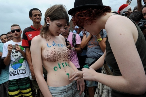 Rio de Janeiro, Rio de Janeiro, BRAZIL: A group of topless women gather on December 21, 2013 at Ipanema beach 