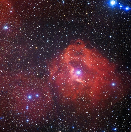 SPACE: A handout photo released on April 14, 2014 by the European Southern Observatory shows a new image from the Wide Field Imager (WFI) on the MPG/ESO 2.2-metre telescope at the La Silla Observatory in Chile, revealing a cloud of hydrogen and newborn stars called Gum 41. In the middle of this little-known nebula, brilliant hot young stars emit energetic radiation that causes the surrounding hydrogen to glow with a characteristic red hue. AFP PHOTO/Ho/European Southern Observatory