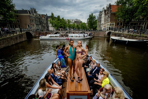 Amsterdam, NETHERLANDS: Models wear swimwear on a boat on a canal during the Fashion Canal Catwalk in Amsterdam, on May 21, 2014. AFP PHOTO/ANP Robin Van Lonkhuijsen 