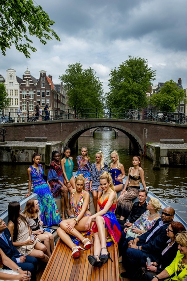 Amsterdam, NETHERLANDS: Models wear swimwear on a boat on a canal during the Fashion Canal Catwalk in Amsterdam, on May 21, 2014. AFP PHOTO/ANP Robin Van Lonkhuijsen