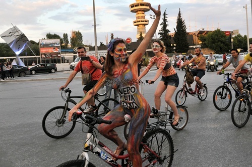 Thessaloniki, GREECE: Cyclists with body paintings participate in a naked ride rally in the streets of Thessaloniki, northern Greece, on June 6, 2014. The event was organised for a 7th year to promote the wider use of bicycles, contributing to the protection of the environment and the reduction of traffic in the city. AFP PHOTO/Sakis Mitrolidis