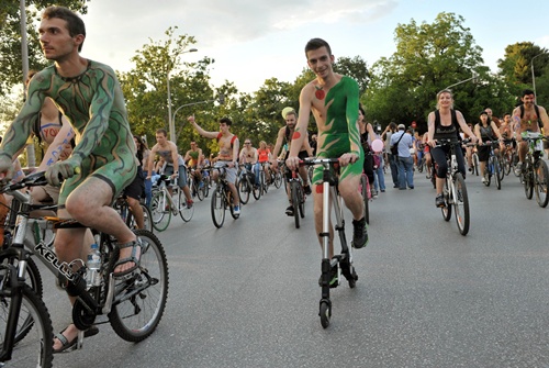 Thessaloniki, GREECE: Cyclists with body paintings participate in a naked ride rally in the streets of Thessaloniki, northern Greece, on June 6, 2014. The event was organised for a 7th year to promote the wider use of bicycles, contributing to the protection of the environment and the reduction of traffic in the city. AFP PHOTO/Sakis Mitrolidis