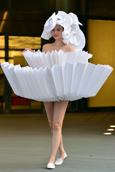 Tokyo, Tokyo, JAPAN: A model displays a dress made from paper using the origami technique designed by Colombia designer Diana Gamboa during an art performance The Cyclops: a love story  in Tokyo on June 14, 2014. AFP PHOTO/Yoshikazu Tsuno