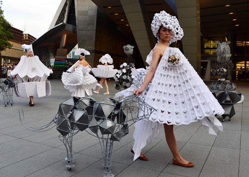 Tokyo, Tokyo, JAPAN: Models display dresses made from paper using the origami technique designed by Colombia designer Diana Gamboa, alongside metal objects produced by Gamboas husband Luis Fernando Bohorquez during an art performance The Cyclops: a love story in Tokyo on June 14, 2014. AFP PHOTO/Yoshikazu Tsuno
