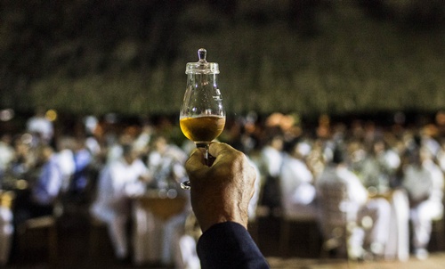 Cartagena, COLOMBIA: A rum expert holds a glass of rum as he makes a presentation during the attempt to establish a new Guinness World Record of the largest rum tasting at the Hotel Caribe in Cartagena, Colombia on September 29, 2014. The New Guinness World Record for the largest rum tasting was achieved with an attendance of 313 people. AFP PHOTO/Joaquin Sarmiento