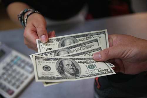 The dollar held steady in Asia Monday after surging on strong US jobs data that fanned expectations the Federal Reserve will hike interest rates sooner that later. -- Photo: AFP