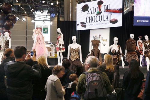 Paris, Paris, FRANCE: Visitors look at dresses made out of chocolate at the Paris Chocolate fair (Salon du Chocolat) on October 29, 2014. AFP PHOTO/Patrick Kovarik