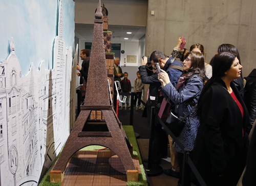 Paris, Paris, FRANCE: Visitors take pictures of chocolate creations in the shape of the Eiffel Tower and other landmarks at the Paris Chocolate fair (Salon du Chocolat) on October 29, 2014. AFP PHOTO/Patrick Kovarik