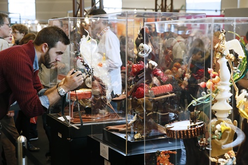 Paris, Paris, FRANCE: A man takes pictures of chocolate creations inspired by Salvador Dali as part of a contest at the Paris Chocolate fair (Salon du Chocolat) on October 29, 2014. AFP PHOTO/Patrick Kovarik