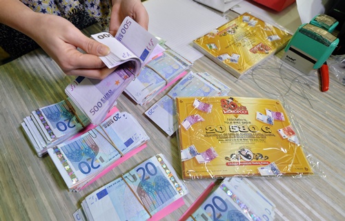 Saint-Avold, Moselle, FRANCE: Employees prepare envelopes with banknotes during a commercial operation of the Monopoly game, on January 13, 2015 in Saint-Avold, eastern France. AFP PHOTO/Patrick Hertzog