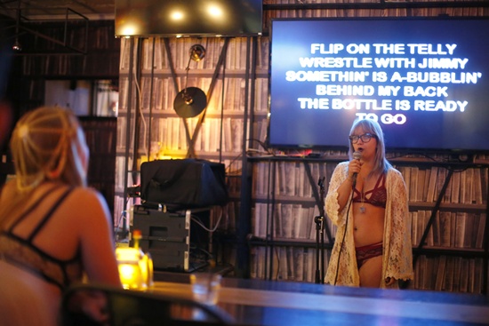 Chelsea Hughes, 25, sings at the first annual Underwear Karaoke, an event that pairs two common fears: being seen in your underwear and singing in public, in Los Angeles, California March 12, 2015. REUTERS/Lucy Nicholson