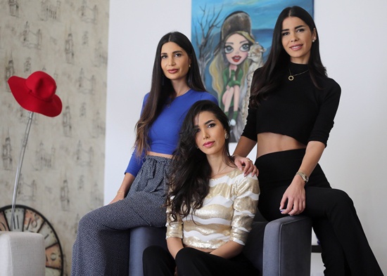 BEIT MISK, LEBANON: Stars of the Lebanese television reality show The Sisters Nadine (C) Alice (L) and Farah (R), known as Abdel Aziz sisters, pose for a picture at their villa in the upscale area of Beit-Misk north east of the capital, Beirut, on April 1, 2015. AFP PHOTO/Joseph Eid