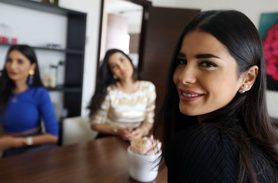 BEIT MISK, LEBANON: Stars of the Lebanese television reality show The Sisters Farah (R), Nadine (C) and Alice (L), known as Abdel Aziz sisters, chat at their villa in the upscale area of Beit-Misk north east of the capital, Beirut, on April 1, 2015. AFP PHOTO/Joseph Eid