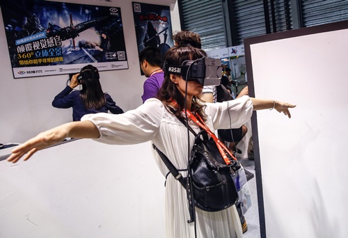 Shanghai, CHINA: Visitors try on Wasai virtual reality glasses during the first Consumer Electronics Show (CES) in Asia in Shanghai on May 25, 2015. AFP PHOTO 