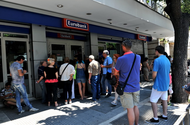 ผู้คนต่อแถวรอกดเงินจากตู้เอทีเอ็มนอกธนาคารแห่งหนึ่งในเมืองเทสซาโลนิกี เมื่อวันจันทร์(6ก.ค.) หลังชาวกรีกมากกว่า 60% ทีเดียว ออกเสียงลงประชามติในวันอาทิตย์ (5 ก.ค.) ปฏิเสธไม่ยอมรับข้อเสนอของฝ่ายเจ้าหนี้ในเรื่องการปฏิรูปอย่างเข้มงวดเพื่อแลกเปลี่ยนกับเงินกู้ ขณะที่บีบีซีนิวส์ออกบทวิเคราะห์โดยวาดภาพสถานการณ์จำลองที่อาจเป็นไปได้ ซึ่งมีอยู่ด้วยกันอย่างน้อย 3 แบบ ทว่าในสถานการณ์จำลองทุกๆ แบบ ปัจจัยชี้ขาดยังคงเป็น สิ่งที่จะเกิดขึ้นกับพวกธนาคารกรีซ และสิ่งที่จะเกิดขึ้นกับเงินอัดฉีดฉุกเฉินจากธนาคารกลางยุโรป (อีซีบี)