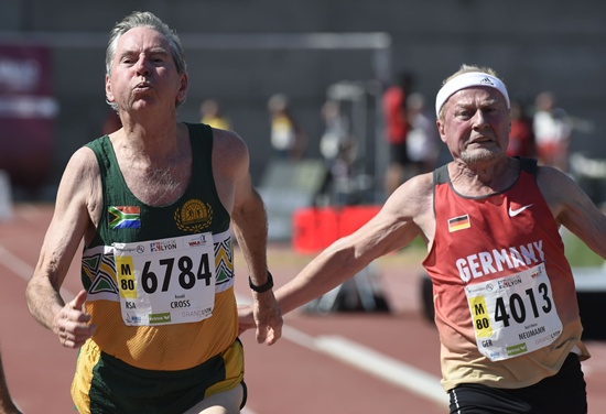 Lyon, Rhone, FRANCE: South Africas Ronald Cross (L) and Germans Karl-Heinz Neumann (R) run during the mens 80-year-old 100m final at the World Masters Athletics Championship on August 7, 2015 in Lyon, central-eastern France. AFP PHOTO/Philippe Desmazes