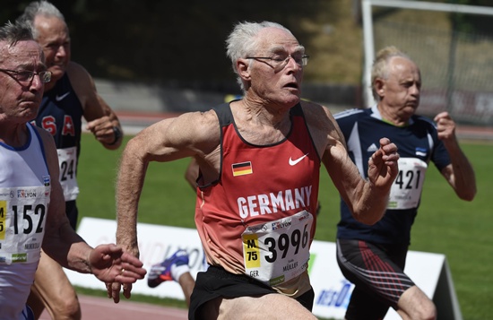 Lyon, Rhone, FRANCE: Germanys Guido Muller (C), Finlands Aimo Mikkola (L) and Estonias Juhan Tennasilm (R) run during the mens 75-year-old 100m final at the World Masters Athletics Championship on August 7, 2015 in Lyon, central-eastern France. AFP PHOTO/Philippe Desmazes