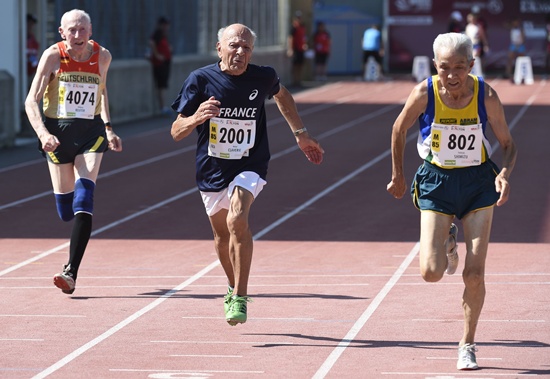 Lyon, Rhone, FRANCE: Brazils Yoshiyuki Shimizu (R), Frances Michel Claverie (C) and Germanys Wolfgang Reuter (L) compete in the mens 100m final for athletes between 85 and 89 years old, during the World Masters Athletics Championships on August 7, 2015 in Lyon, southeastern France. AFP PHOTO/Philippe Desmazes