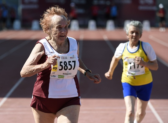 Lyon, Rhone, FRANCE: Lithuanias Austra Reinberga (L) runs next to Columbias Maria Pastora Londono during the womens 100m final for athletes between 85 and 89 years old, during the World Masters Athletics Championships on August 7, 2015 in Lyon, southeastern France. AFP PHOTO/Philippe Desmazes
