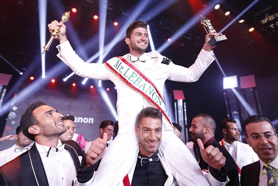 Jounieh, LEBANON: Farid Matar (top) celebrates after winning the Mr. Lebanon title during the beauty contest at Casino du Liban in Jounieh, north of the Lebanese capital Beirut, on September 4, 2015. AFP PHOTO/Anwar Amro
