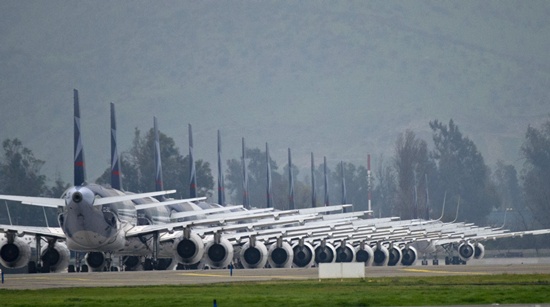 Santiago, CHILE: LAN airliners remain idle on the tarmac of the Arturo Merino Benitez International Airport in Santiago due to a Direction of Civil Aviation workers strike on September 15, 2015. Airport workers staged a 24-hour strike Tuesday in Chile, grounding flights across the country and disrupting travel plans for an estimated 70,000 passengers. AFP PHOTO/Martin Bernetti