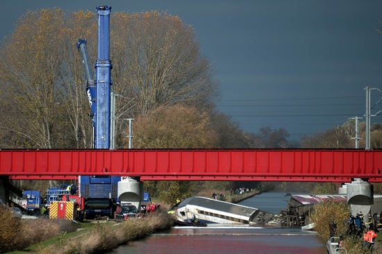 Eckwersheim, Bas-Rhin, FRANCE: Emergency personnel work at an accident scene on November 15, 2015 where a high-speed TGV train coach and engine carriage lie, in a canal in Eckwersheim near Strasbourg, northeastern France, after derailing on November 14 during a test conducted by technicians, French railway operator SNCF said. Ten people were killed in a French high-speed train test on November 14, due to excessive  speed, sources said. AFP PHOTO/Frederick Florin