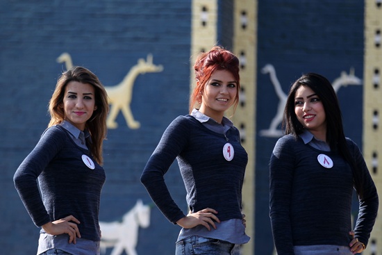 hilla, IRAQ: Iraqi candidates for Miss Iraq beauty contest pose in front of the Ishtar Gate at the ancient archaeological site of Babylon, outside the modern city of Hilla, south of the capital Baghdad on December 17, 2015. AFP PHOTO/Ahmad Al-Rubaye