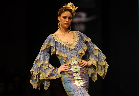 Sevilla, SPAIN: A model presents creations by Loli Vera during the SIMOF 2016 (International Flamenco Fashion Show) in Sevilla, on February 6, 2016. AFP PHOTO/Cristina Quicler