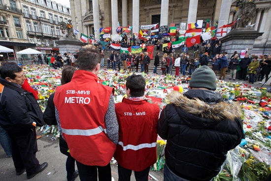 Brussels: Workers of Brussels public transport company STIB-MIVB gather to pay a tribute in the square outside the stock exchange in Brussels on March 27, 2016 an area which has become an unofficial shrine to victims of the March 22, terror attacks claimed by the Islamic State (IS) group in which 31 people were killed and over 300 injured. Police fired water a cannon at far-right football hooligans who invaded a square in the Belgian capital that has become a memorial to the victims of the Brussels attacks, an AFP journalist said. Police took action after about 200 black-clad hooligans shouting nationalist and anti-immigrant slogans moved in on the Place de la Bourse where people were gathering in a show of solidarity with the victims. AFP/Belga/Nicolas Maeterlinck