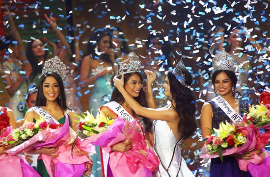 Manila: This photo taken on April 17, 2016 shows Miss Universe 2015 Pia Wurtzbach (2nd R) giving the Miss Philippines crown to her successor, Maxine Medina during the coronation night of the 2016 Binibining Pilipinas beauty pageant in Manila. AFP/STR