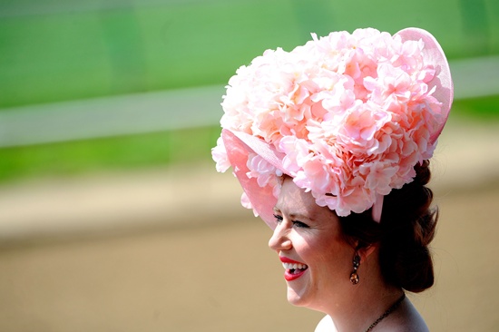 Louisville, Kentucky, UNITED STATES: A woman wearing a festive hat looks on prior to the 142nd running of the Kentucky Oaks at Churchill Downs on May 06, 2016 in Louisville, Kentucky. Logan Riely/Getty Images/AFP