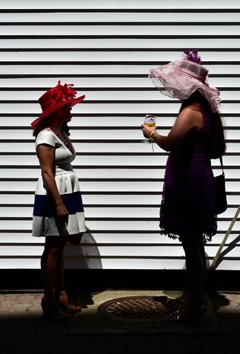 Louisville, Kentucky, UNITED STATES: Women wearing festive hats talk prior to the 142nd running of the Kentucky Oaks at Churchill Downs on May 06, 2016 in Louisville, Kentucky. Logan Riely/Getty Images/AFP