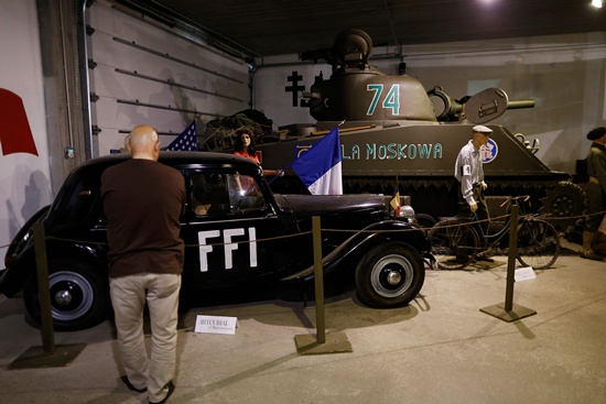 Catz, Manche, France: This picture taken on September 12, 2016 in Catz, northwestern France shows a 1947 Citroen Traction 11BL (L) at the Normandy Tank Museum. The Normandy Tank Museums closure puts WWII items for sale, including tanks and other WWII items, in an auction to be held on September 18. AFP/Charly Triballeau