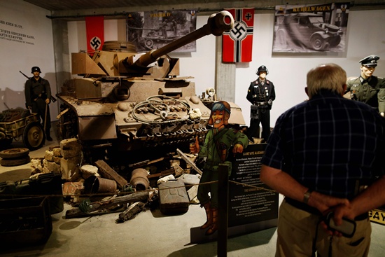 Catz, Manche, France: This picture taken on September 12, 2016 in Catz, northwestern France shows people visiting the Normandy Tank Museum. The Normandy Tank Museums closure puts WWII items for sale, including tanks and other WWII items, in an auction to be held on September 18. AFP/Charly Triballeau