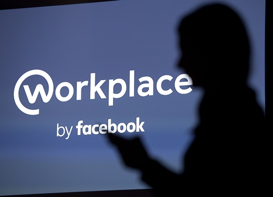 London: A logo for Facebooks Workplace is seen in this posed photograph following the social media companys launch event for the product Workplace, in central London on October 10, 2016. Social network giant Facebook launched new global product Workplace, a platform that it hopes will replace intranet, mailbox and other internal communication tools used by businesses worldwide. It is intended to compete with similar office communication products including Microsofts Yammer, Salesforces Chatter and Slack. AFP/Justin Tallis