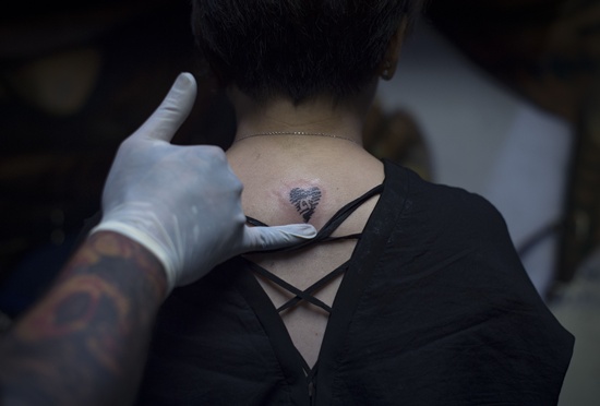 Bangkok: This photo taken on October 18, 2016 shows a finished tattoo of a heart with the number 9 in honour of the late Thai King Bhumibol Adulyadej at Tattoo OD Studio in Bangkok. AFP/Lillian Suwanrumpha