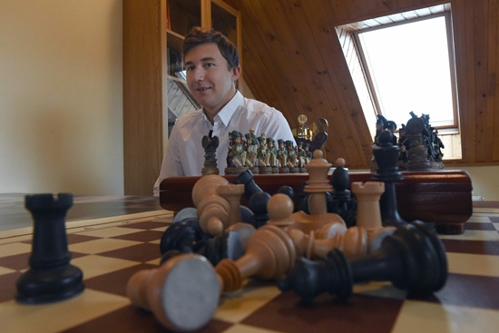 Moscow: A picture taken on September 19, 2016 shows Russian grandmaster Sergei Karyakin looking on during an interview with AFP at his home outside Moscow. Sitting next to an ornate chess board in his home outside Moscow, Russian grandmaster Sergei Karyakin lowers his gaze as he ponders how to beat reigning world champion Magnus Carlsen. Next month Karyakin, 26, will have his stab at dethroning Carlsen, 25, in New York as he takes on the Norwegian phenomenon in a 600,000-euro ($668,000) match up some are hyping as a clash between East and West that echoes the Cold War. AFP/Vasily Maximov