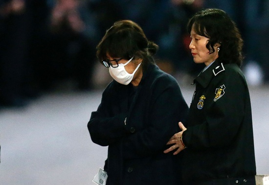 Seoul: (FILES) This file photo taken on November 3, 2016 shows Choi Soon-Sil (L), the woman at the heart of a lurid political scandal engulfing South Koreas President Park Geun-Hye is escorted following her formal arrest, from the Central District Court in Seoul. AFP/Korea Pool